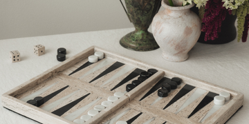 Handmade marble backgammon set being played on table