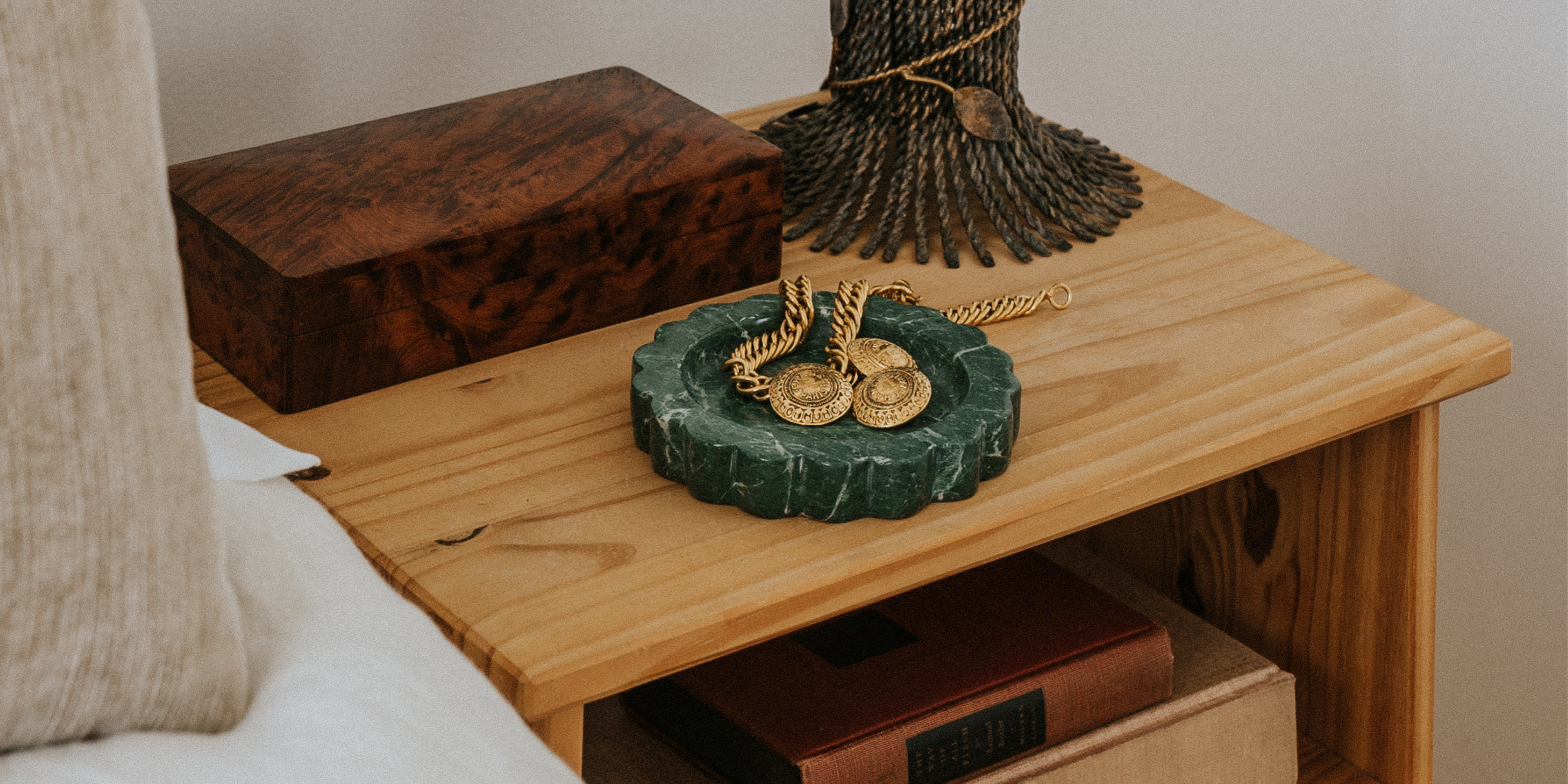 Marble catchall styled on a bedside table to organize jewelry