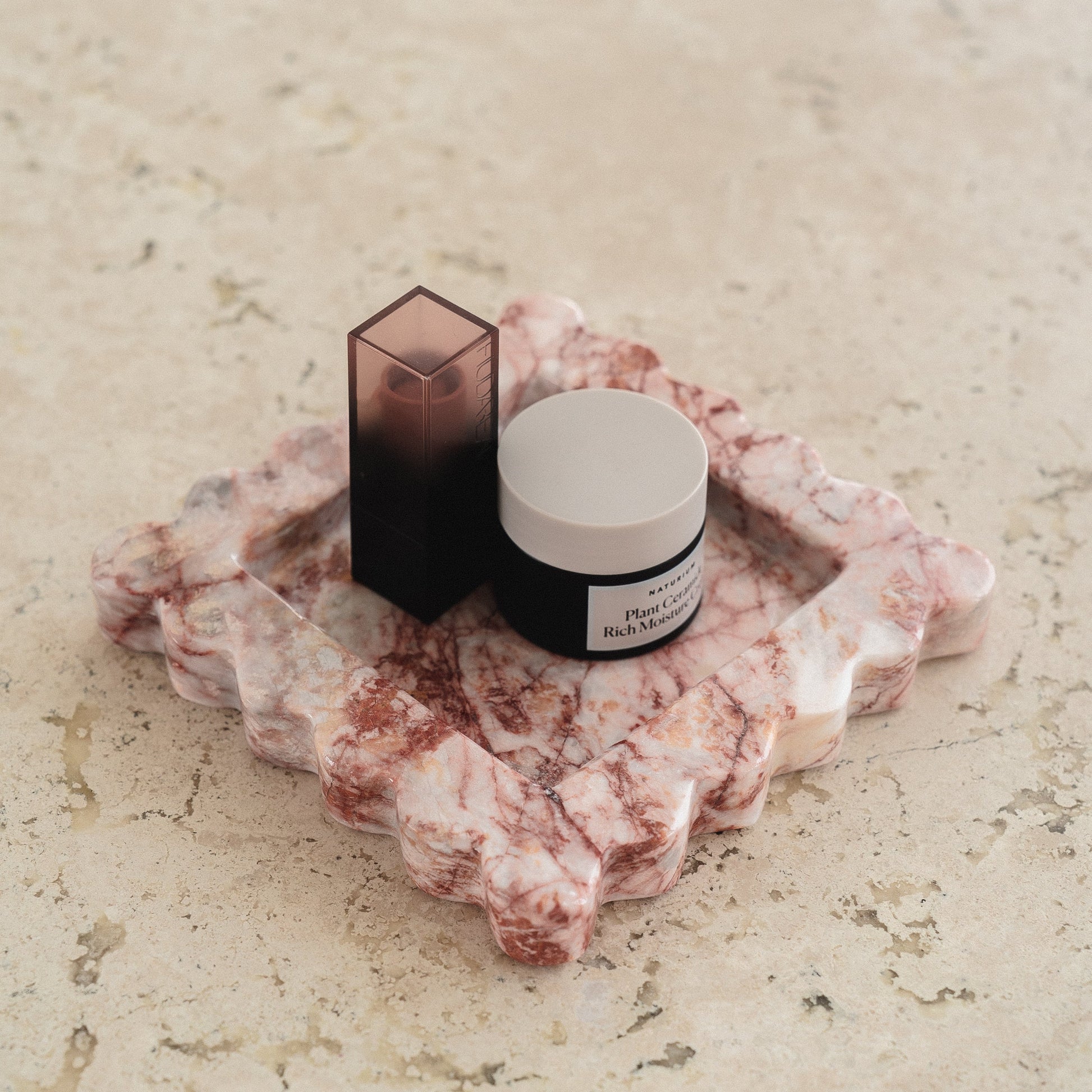 scalloped stone catchall tray as makeup organizer