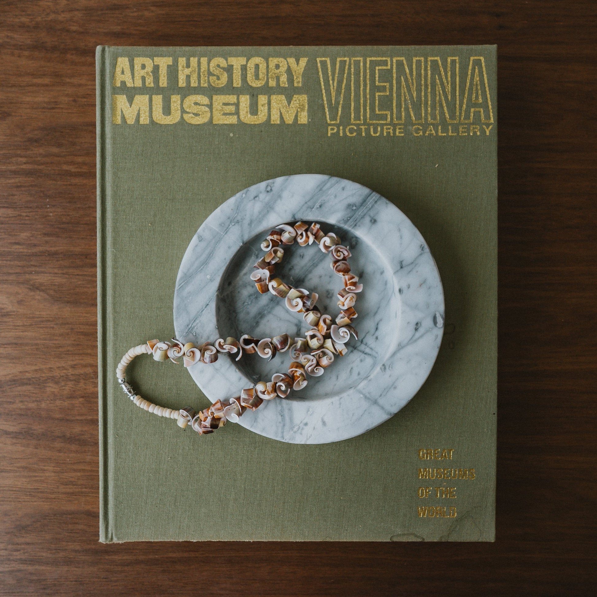 blue marble jewelry catch all styled on coffee table book