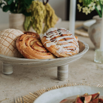 natural stone footed serving dish holding pastries