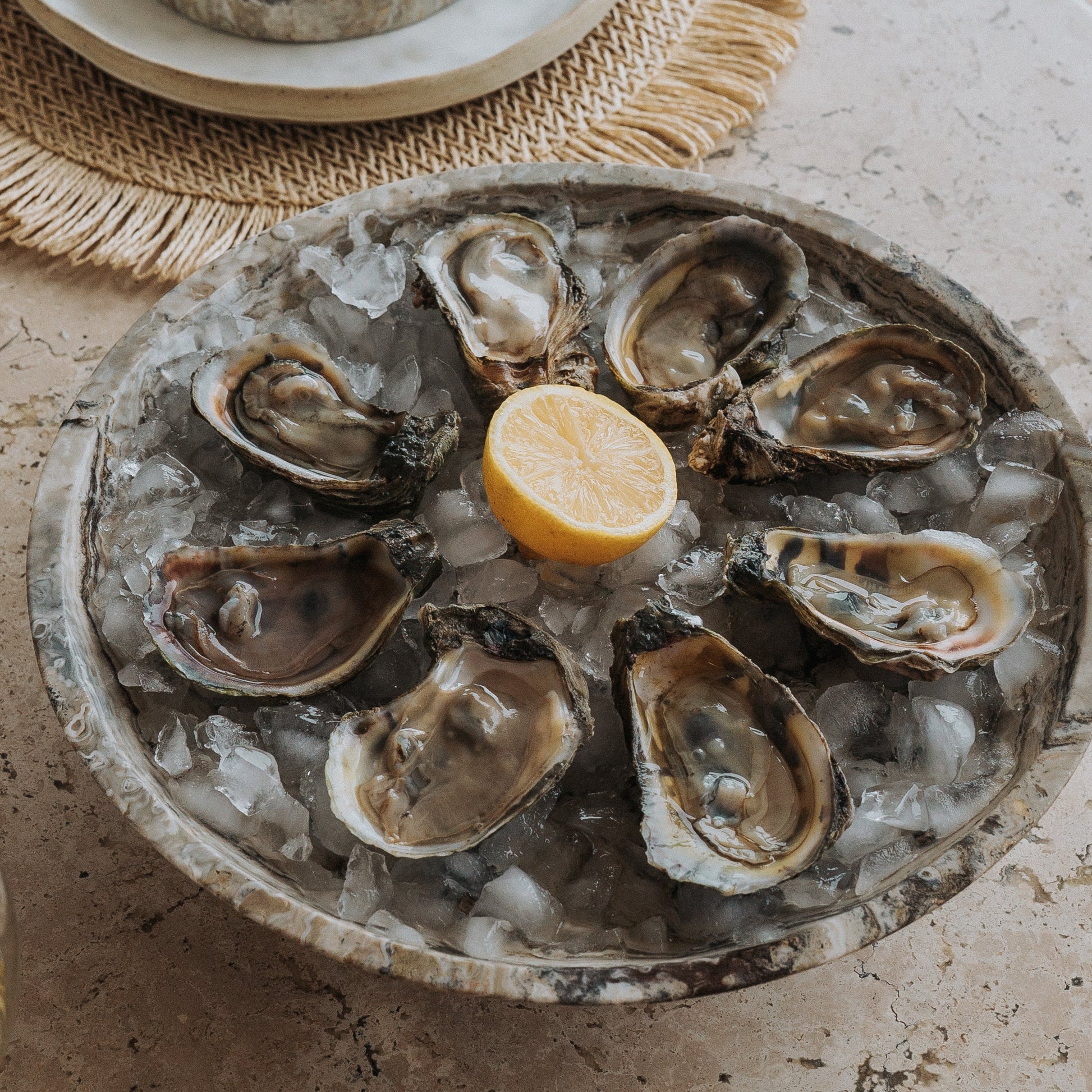 natural stone serving dish serving oysters on travertine table
