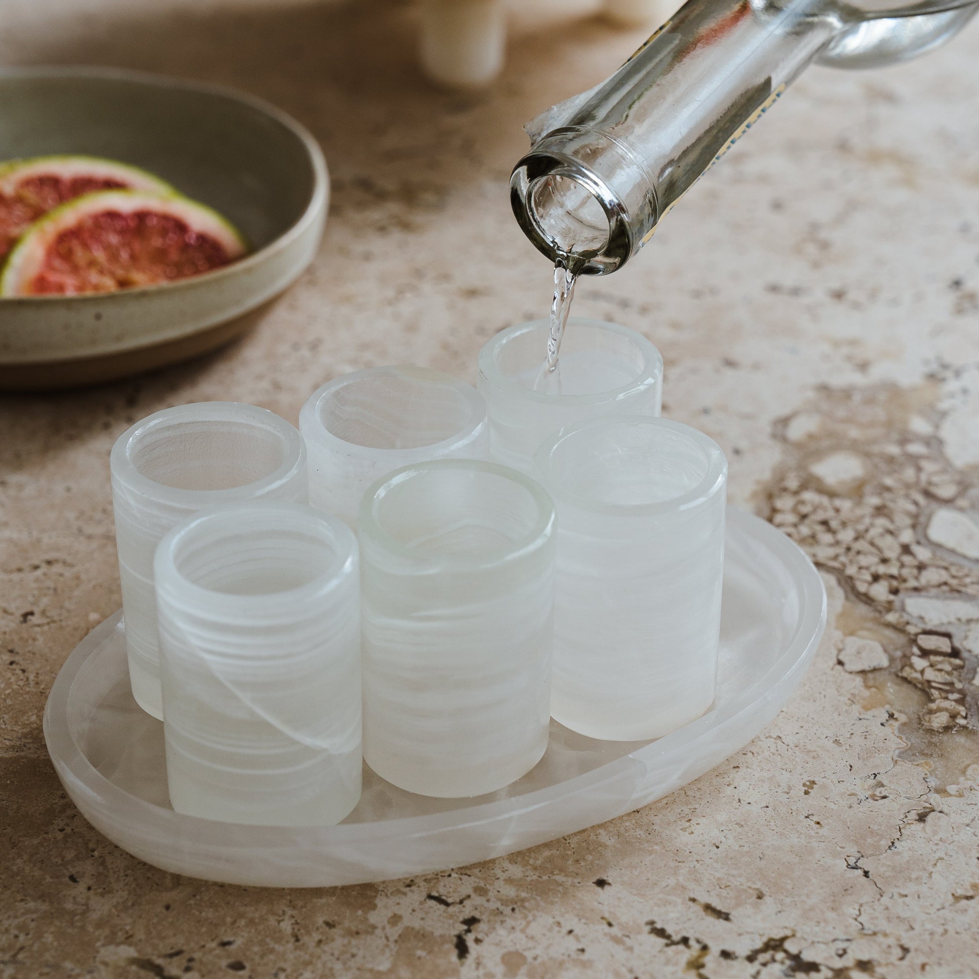 serving tequila in white onyx shot glass