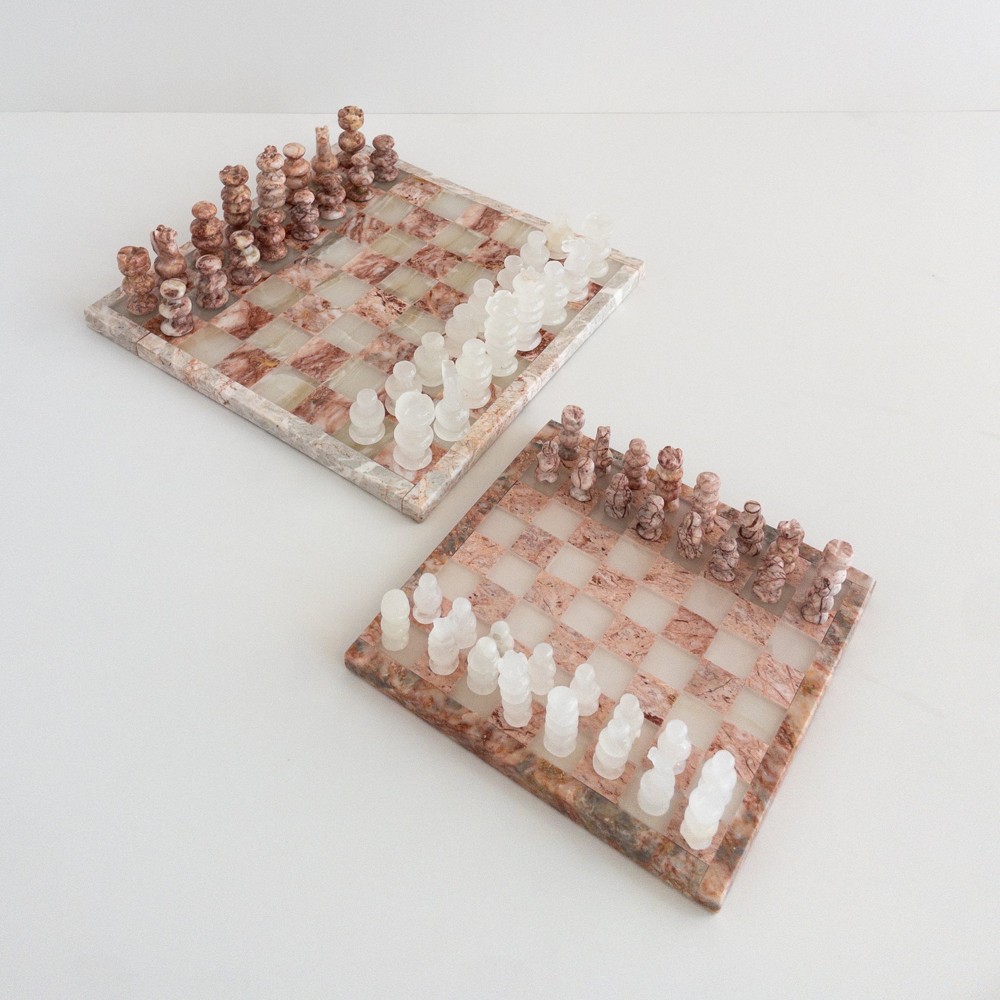 close-up of pink marble chess set with natural veining