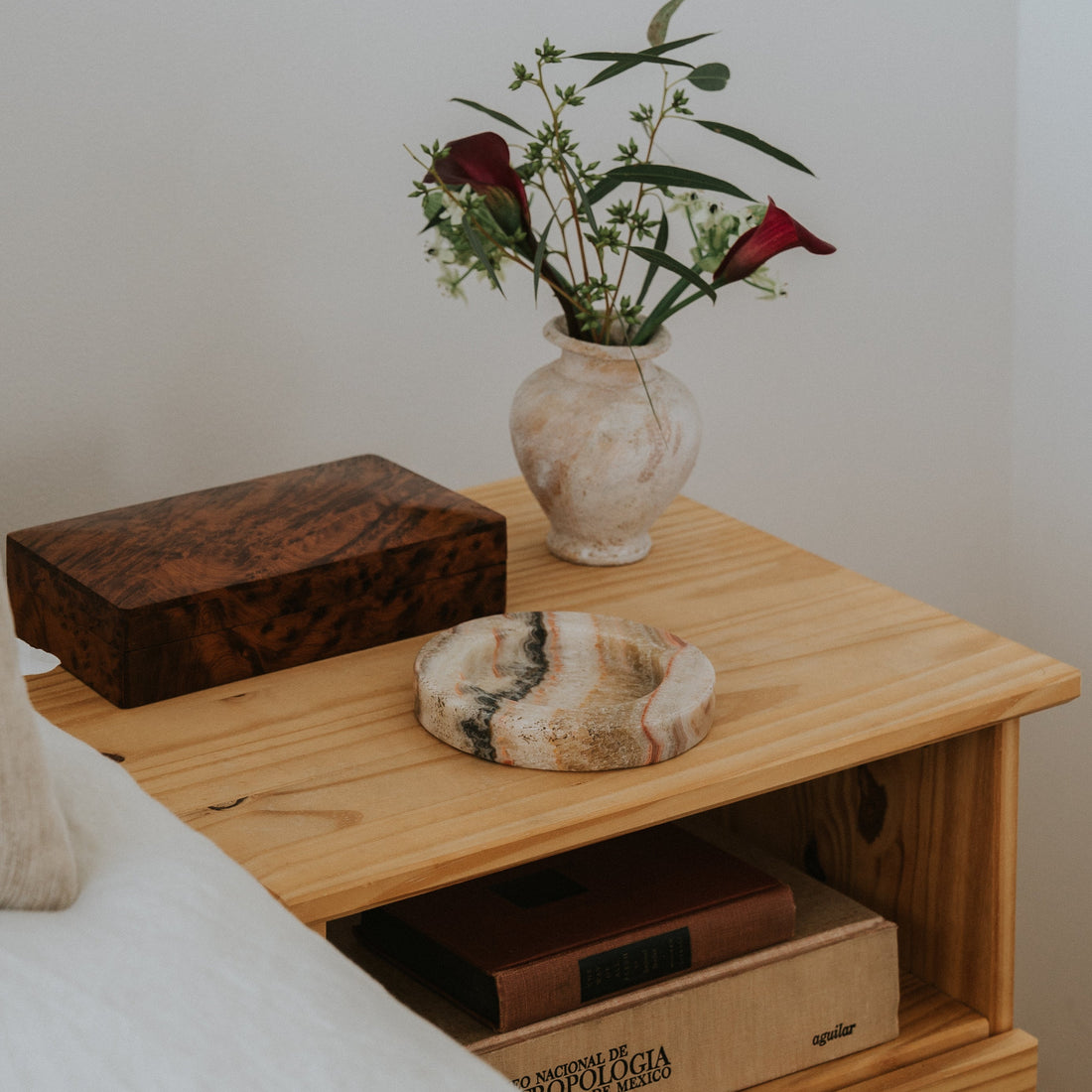 white onyx jewelry tray on bedside table