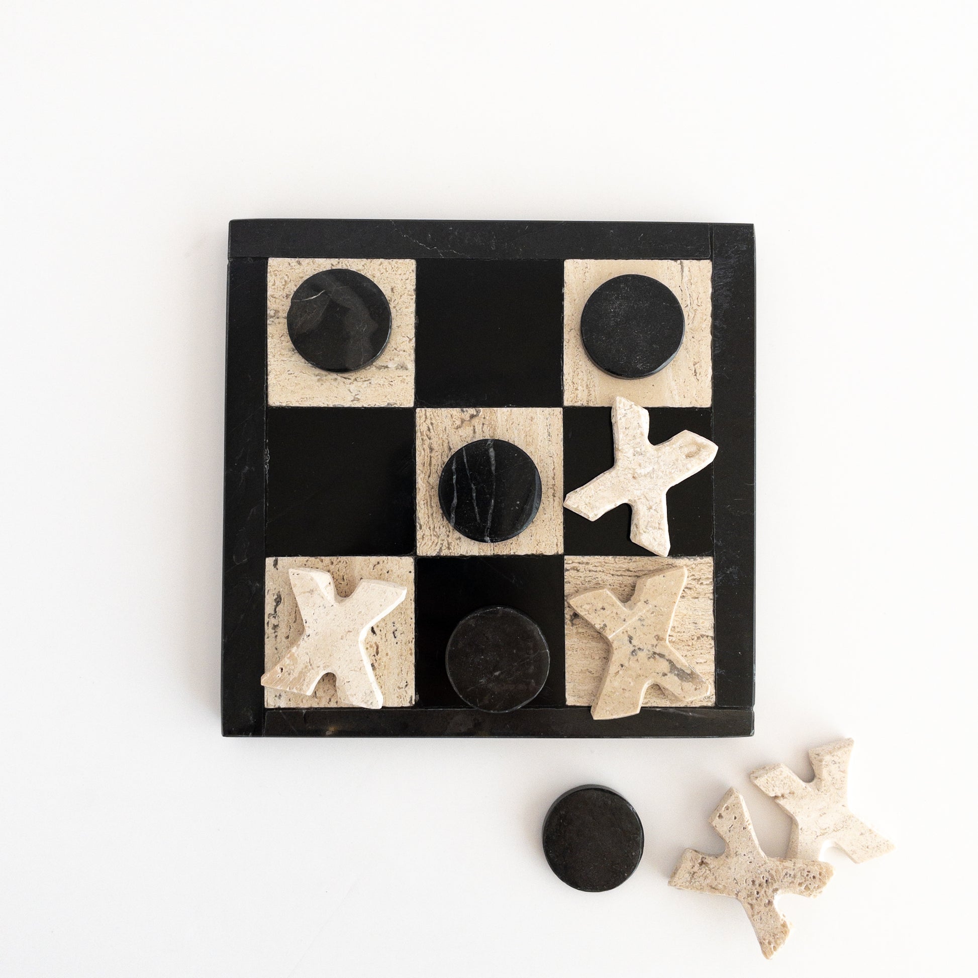 polished stone game board with marble pieces