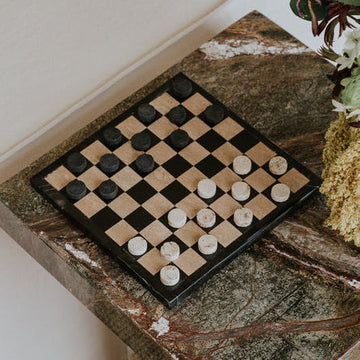 stone checkers game on side table