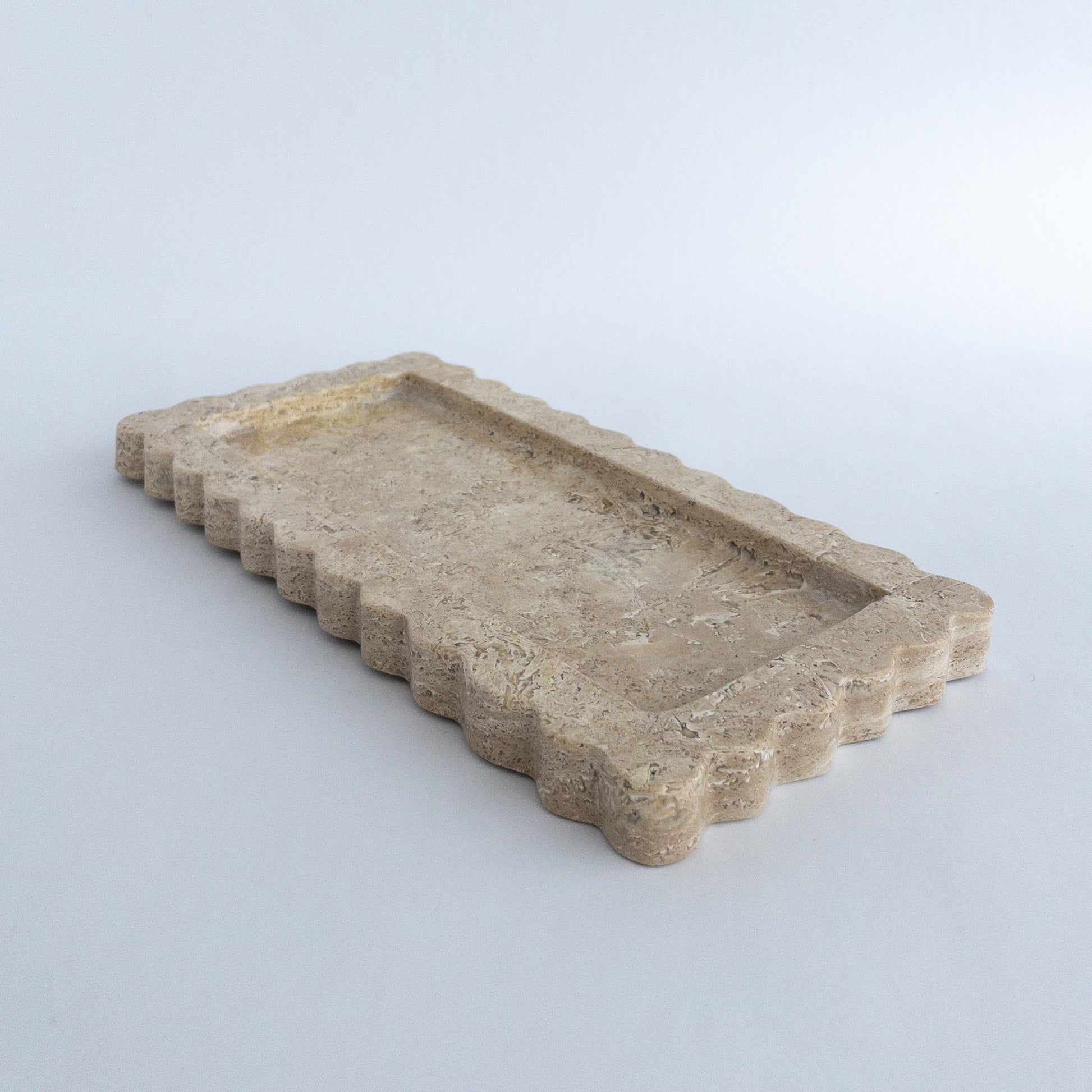 close up of scalloped edge on travertine tray