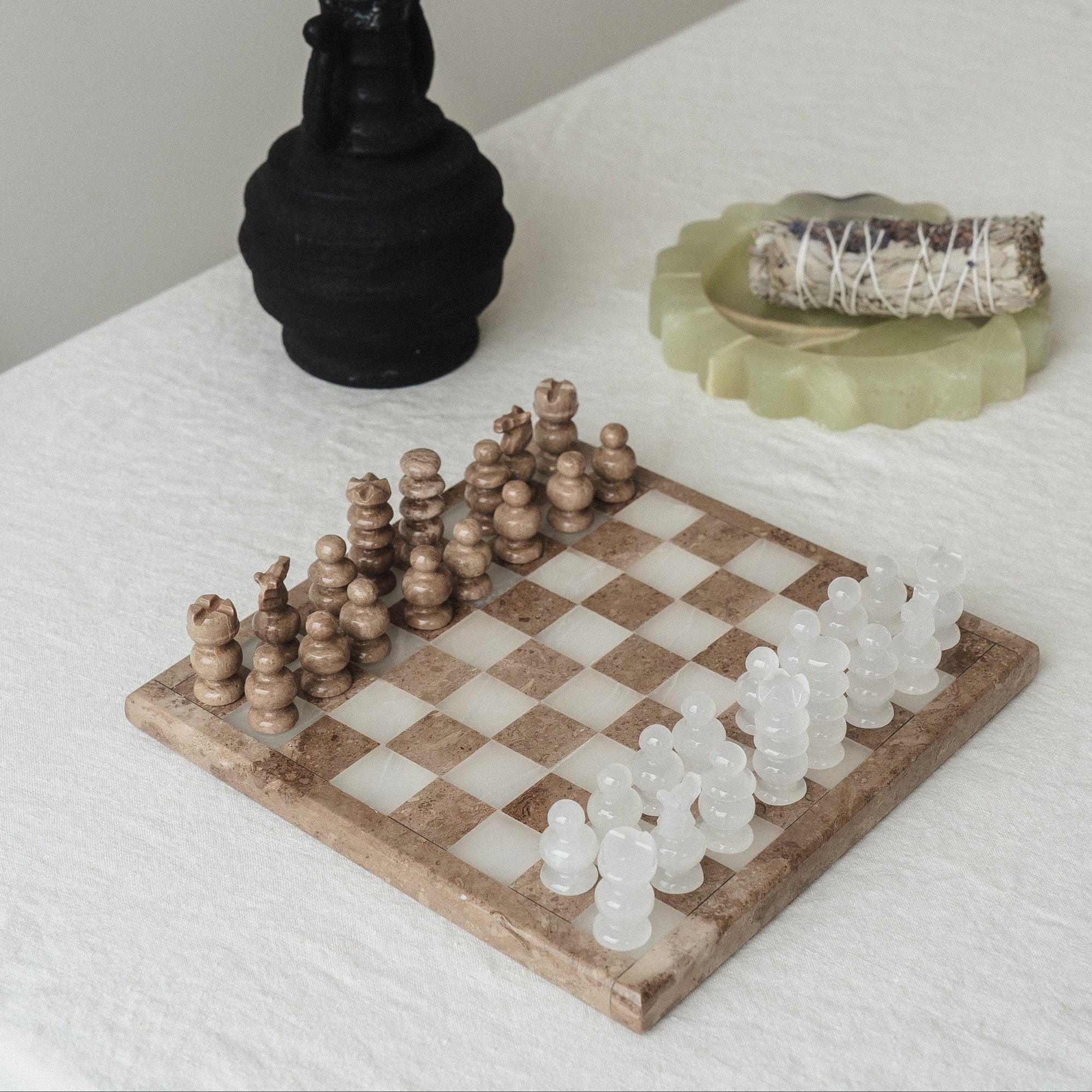 stone chess set on table with vase
