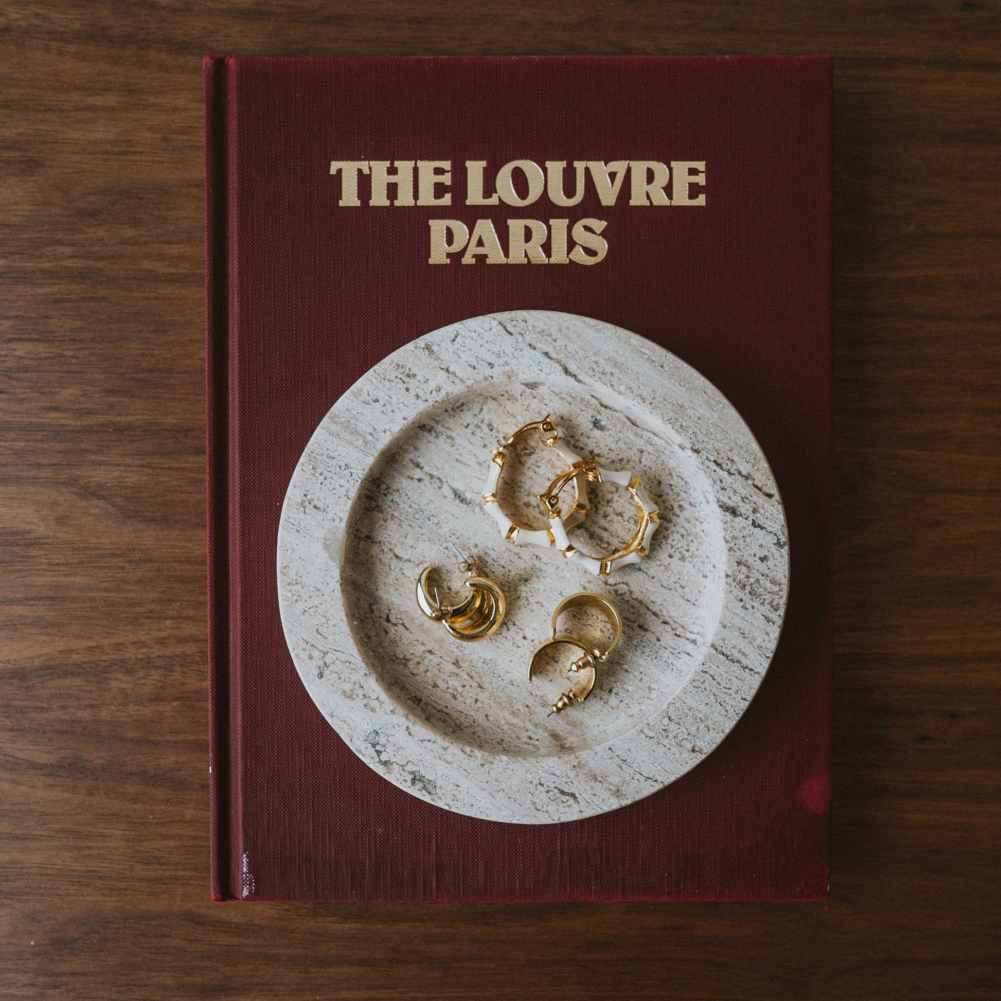 travertine jewelry catch all styled on coffee table book