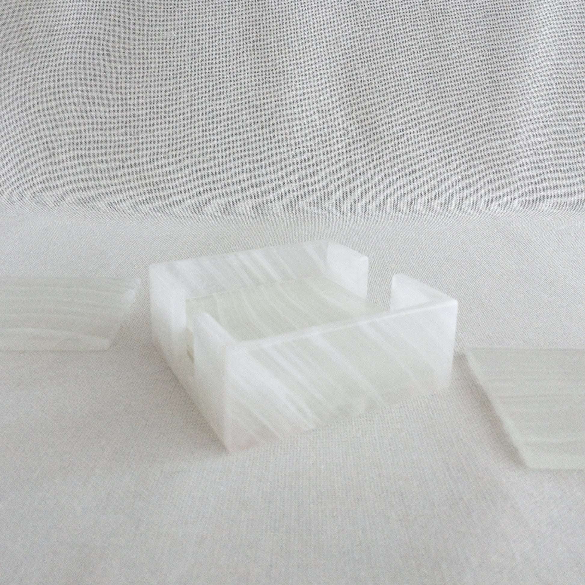 detail of white onyx coasters storage case with unique veining