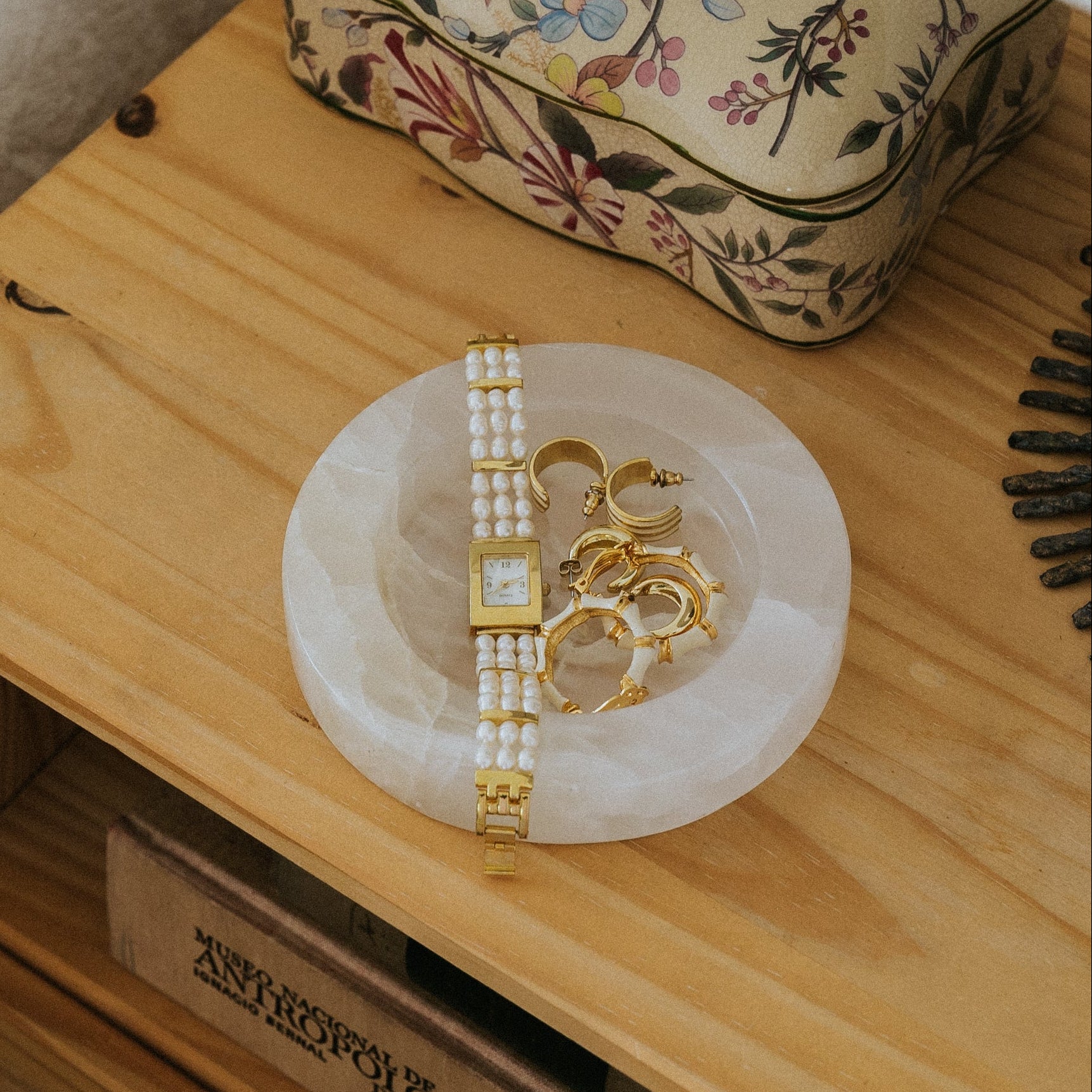 white onyx jewelry tray on bedside table