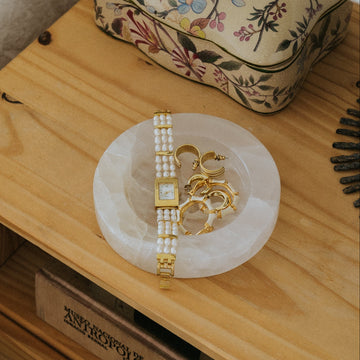 white onyx jewelry tray on bedside table