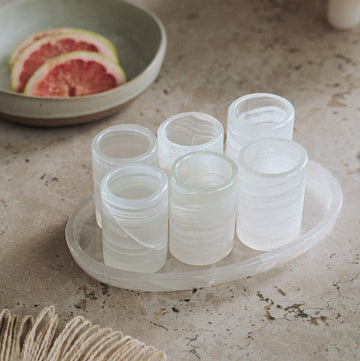 onyx shot glasses on travertine table